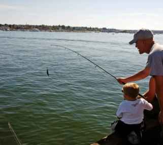 Father_and_son_fishing_little_boy_helps_his_father_to_fish.jpg